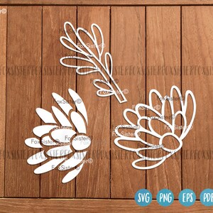 May include: White silhouette cutouts of a protea flower and a branch with leaves. The cutouts are on a wood background. The text "FoxSister" is in the top left corner of the image.