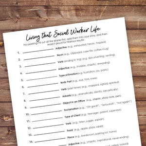 May include: A white fill-in-the-blanks game sheet titled "Living that Social Worker Life" with prompts for adjectives, nouns, verbs, and more. The sheet is on a wooden surface.
