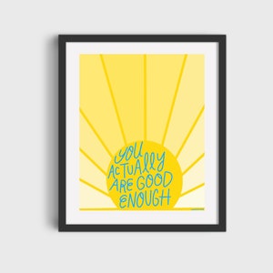 May include: A yellow sun with rays emanating from it. The sun has the text "you actually are good enough" written in blue on it.