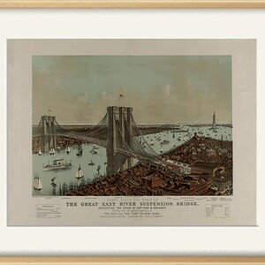 May include: A framed vintage print titled "The Great East River Suspension Bridge." The artwork depicts a detailed bird's-eye view of the bridge, with boats and buildings in the background. The print is in a light wood frame.