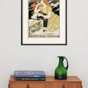 May include: A vintage poster advertising "Encre L'Marquet" ink. The poster features a woman with red hair writing at a desk with a quill pen. The text "LA MEILLEURE DE TOUTES LES ENCRES" is at the bottom of the poster.