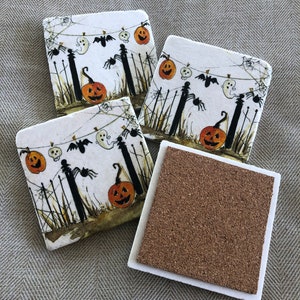 May include: Set of four square Halloween coasters. Each coaster features a spooky scene with jack-o'-lanterns, ghosts, bats, and spiders. The coasters have a white top with a cork bottom for absorbing moisture.