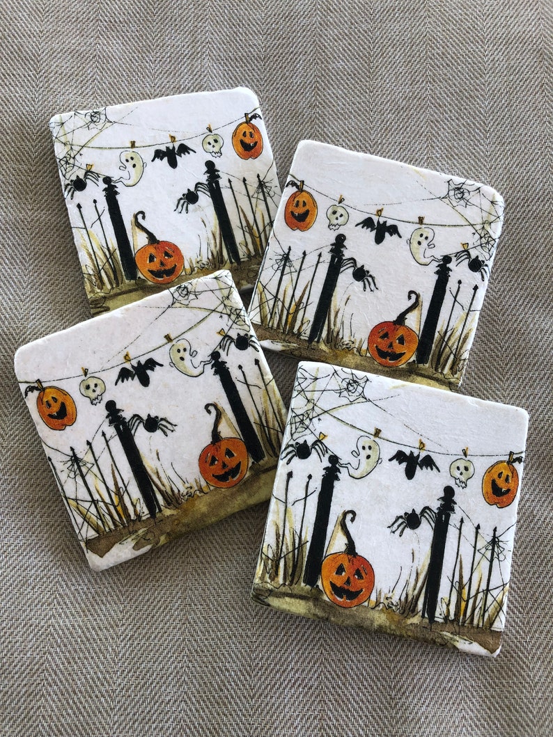 May include: Four square Halloween coasters with a festive design. Each coaster features a white background with a spooky scene of jack-o'-lanterns, ghosts, bats, and spiders. The coasters are perfect for adding a touch of Halloween spirit to any home.