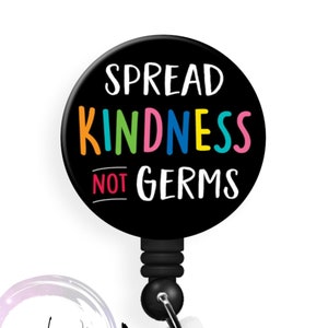 May include: Black retractable badge reel with a round, black button that says "SPREAD KINDNESS NOT GERMS" in colorful letters.