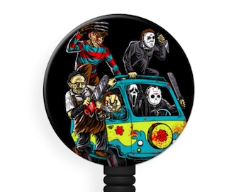May include: A black and white round badge reel with a colorful image of horror movie characters riding in a van. The characters include Freddy Krueger, Jason Voorhees, Michael Myers, and Ghostface. The van is blue and green with a flower design.