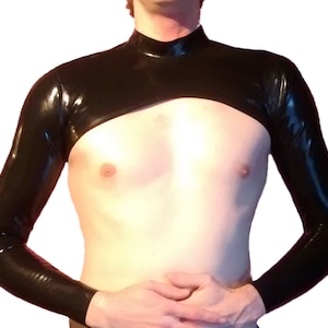 May include: A black latex top with long sleeves. The top is cropped and has a high neck.