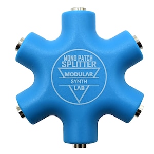 May include: A blue 5-way mono patch splitter with the text "MONO PATCH SPLITTER MODULAR SYNTH LAB" printed on the front.