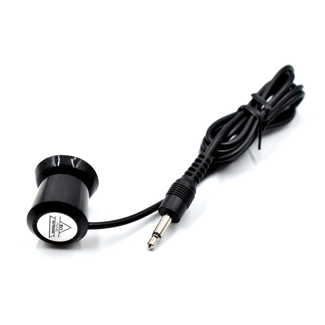 Telephone tap microphone against a white background