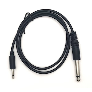 May include: A black audio cable with a 1/4 inch (6.35 mm) male connector on one end and a 1/8 inch (3.5 mm) male connector on the other. The cable is coiled and lies on a white surface.