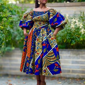 FAHRA swing dress in a mixed print with statement sleeves.