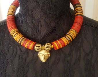 African beaded necklace with bronze African mask pendant.