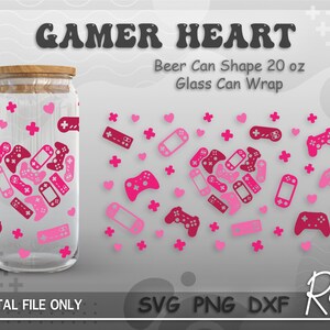May include: A digital download design for a 20 ounce beer can wrap featuring a pink and red gamer heart design with game controllers and hearts. The design is for a glass can wrap. The text "GAMER HEART" is at the top of the design. The text "Beer Can Shape 20 oz Glass Can Wrap" is below the design. The text "DIGITAL FILE ONLY" is at the bottom left of the design. The text "SVG PNG DXF" is at the bottom center of the design. The text "Room 1213" is at the bottom right of the design.