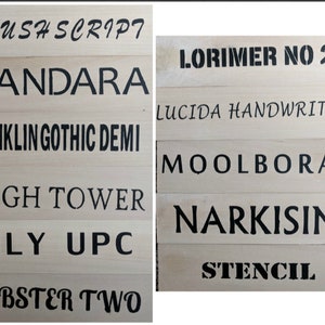 May include: Wooden planks with black text displaying various font names, including "BRUSH SCRIPT", "CANDARA", "FRANKLIN GOTHIC DEMI", "HIGH TOWER", "LILY UPC", "LOBSTER TWO", "LORIMER NO 2", "LUCIDA HANDWRITING", "MOOLBORAN", "NARKISIM", and "STENCIL".