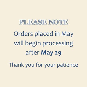 May include: Cream-colored background with blue text. The text reads "PLEASE NOTE" at the top, followed by information about order processing in May. It concludes with "Thank you for your patience."
