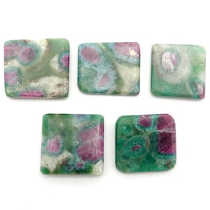 May include: Five square-shaped green, pink, and white gemstone cabochons. The cabochons have a mottled pattern and are approximately 1 inch in size.