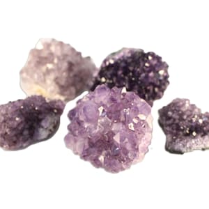 May include: A group of five amethyst crystal clusters in various shades of purple. The crystals are rough and have a natural, unpolished look.