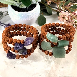 May include: Two sets of brown beaded bracelets with gemstone accents. One set features amethyst stones, the other set features green aventurine stones.