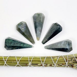 May include: Five green and white agate crystal points arranged in a semi-circle on a white background. The points are all about 2 inches long and have a smooth, polished finish.