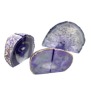 May include: Three purple agate bookends. Two bookends are joined together and the third is a single piece.
