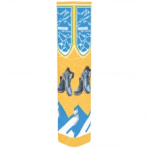 May include: A tall, cylindrical display banner featuring a yellow background with a topographic line pattern. It displays two blue shield-shaped emblems with white mountain illustrations and the text "MOUNTAINS ARE CALLING" above hiking boots.