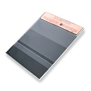 May include: A grey and white striped acrylic sheet with a pink label that reads "Art by Jaber Petersen | www.willardstore | @willardartdesigns".