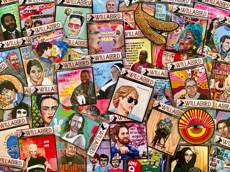 May include: A collection of colourful, hand-painted enamel pins featuring various pop culture figures and quotes. The pins are displayed on a white background and feature a variety of designs, including a banana, a woman with a crown, a man with a moustache, and a woman with a cat. The pins are all square-shaped and have a glossy finish.