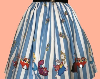 May include: A pleated skirt featuring vertical light blue and white stripes with a repeating pattern of characters from Alice in Wonderland, including the White Rabbit and Cheshire Cat. The skirt has a wide black elastic waistband with a gold buckle.