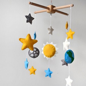 Space baby crib mobile with the Earth, moon, Sun and stars