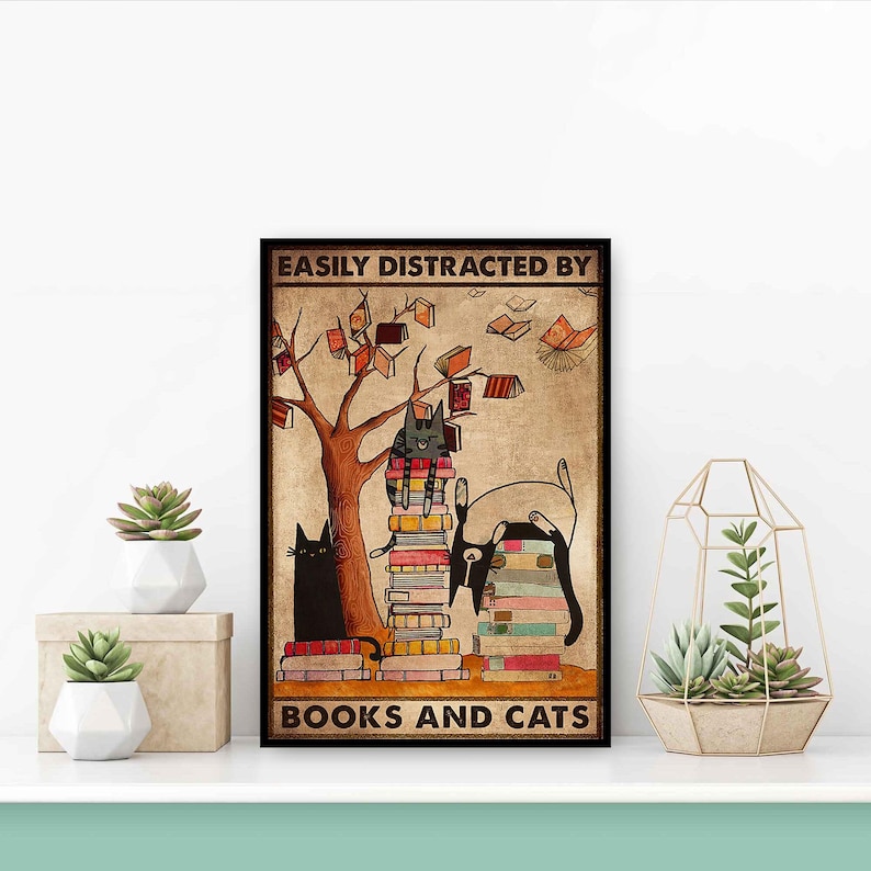 May include: A brown and tan poster with a black cat sitting on a stack of books. The poster has the text "Easily Distracted By Books And Cats" and a tree with leaves and books hanging from the branches.