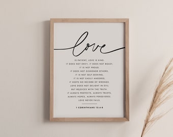 May include: A framed print with a white background and black text. The text reads "love is patient, love is kind... love never fails" and "1 Corinthians 13:4-8".