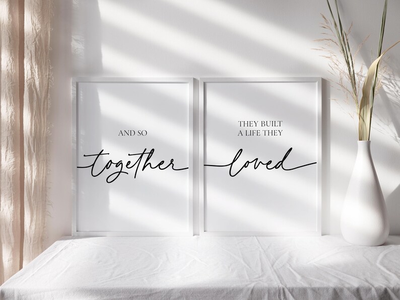 May include: Two white framed prints with black text. The left print says "And so together". The right print says "They built a life they loved".