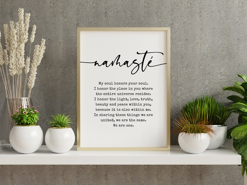 May include: A black and white printable wall art print with a gold frame. The print features the word "namaste" in a cursive font and a quote about honoring the soul. The quote reads: "My soul honors your soul. I honor the place in you where the entire universe resides. I honor the light, love, truth, beauty and peace within you, because it is also within me. In sharing these things we are united, we are the same. We are one."
