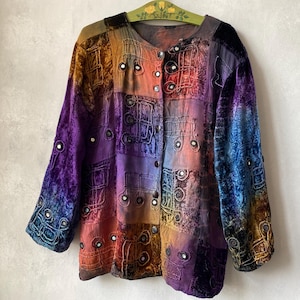May include: A long-sleeved jacket featuring a multi-colored tie-dye pattern in shades of purple, blue, orange, and brown. The garment is decorated with intricate raised stitching and small circular mirror accents throughout the front and sleeves.