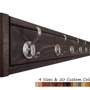 May include: A dark brown wooden coat rack with 8 silver hooks. The rack is 48 inches long and has a 2-inch wide frame. The hooks are 3 inches long and have a 1-inch diameter base. 4 Sizes & 20 Custom Colors
