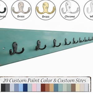 May include: A teal-painted wooden coat rack with multiple black metal hooks. The rack has a distressed finish and is shown with different hook finishes: oiled bronze, brass, chrome, and white. Text at the bottom reads "20 Custom Paint Color & Custom Sizes."