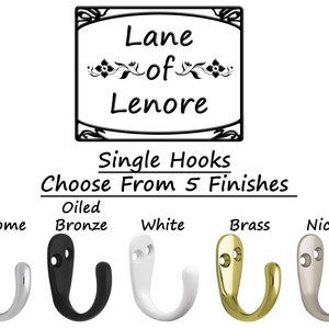 May include: Image of single hooks in five finishes: chrome, oiled bronze, white, brass, and nickel. The text "Lane of Lenore" is displayed above the hooks, with the text "Single Hooks Choose From 5 Finishes" below.