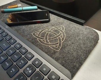 Felt pad between keyboard and monitor embroidered with "Triquetra"