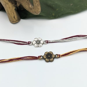 Burgundy Silver Gold Flower Rakhis | Burgundy Threaded Rakhi with Silver or Antique Gold Flower Charm