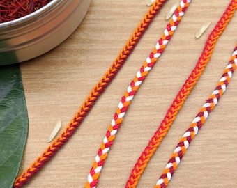 編み込みラキス - 赤、オレンジ、白 |ラクシャ バンダン 2025 |兄弟のためのラキ ブレスレット