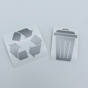 May include: Two silver vinyl stickers, one with a recycle symbol and the other with a trash can icon.