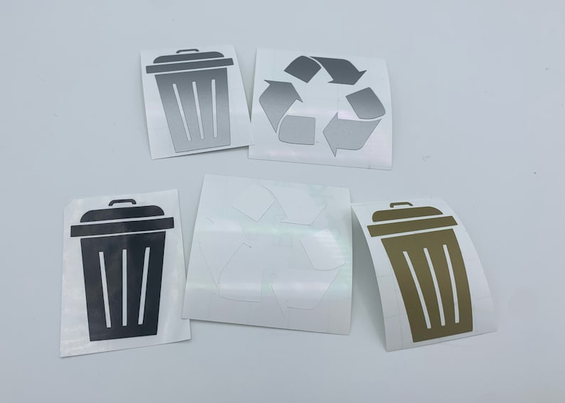 May include: Five vinyl stickers, two are black trash cans, one is gold, and two are silver recycle symbols.