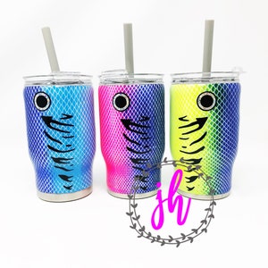 May include: Three stainless steel tumblers with lids and straws. Each tumbler features a different color gradient design with a fish lure pattern and a black eye.