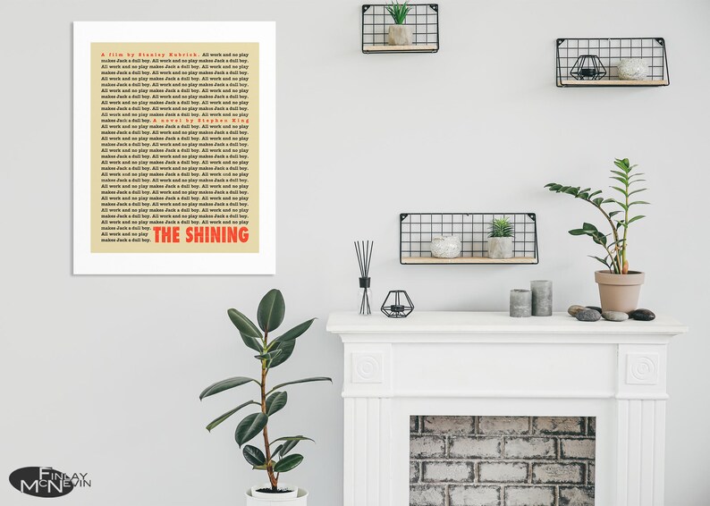 May include: A beige poster with the title "The Shining" in red text. The poster is a film and novel credit for the movie "The Shining" by Stephen King.