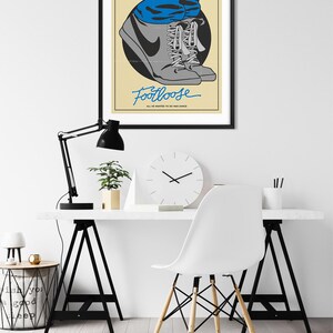 May include: A retro-style poster for the movie Footloose, featuring a pair of grey sneakers with blue laces and a blue jean leg. The text "Footloose" is written in blue cursive script with the tagline "All he wanted to do was dance".
