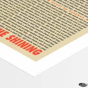 May include: A vintage-style poster for the movie "The Shining" by Stephen King. The poster features the movie title in red text with a white background. The text "All work and no play makes Jack a dull boy" is repeated multiple times in black text.