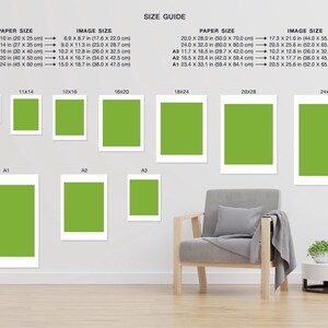 May include: A size guide for prints, showing different paper and image sizes in inches and centimeters. The guide includes sizes from 8x10 inches to 24x32 inches. The image shows a living room with a chair and a side table.
