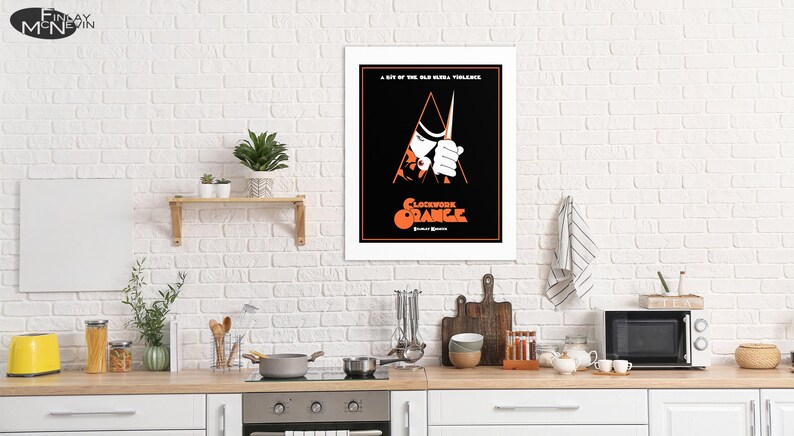 May include: A black and white poster with a red and orange title that reads "Clockwork Orange". The poster features a man in a white shirt and black hat holding a knife.