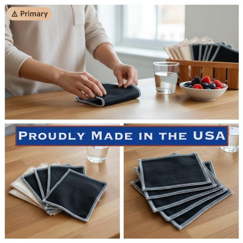 May include: Dark gray square cloths with white stitching are displayed on a wooden table. The cloths are being folded by a person. The image also shows a bowl of berries, a glass of water, and the text "PROUDLY MADE IN THE USA".