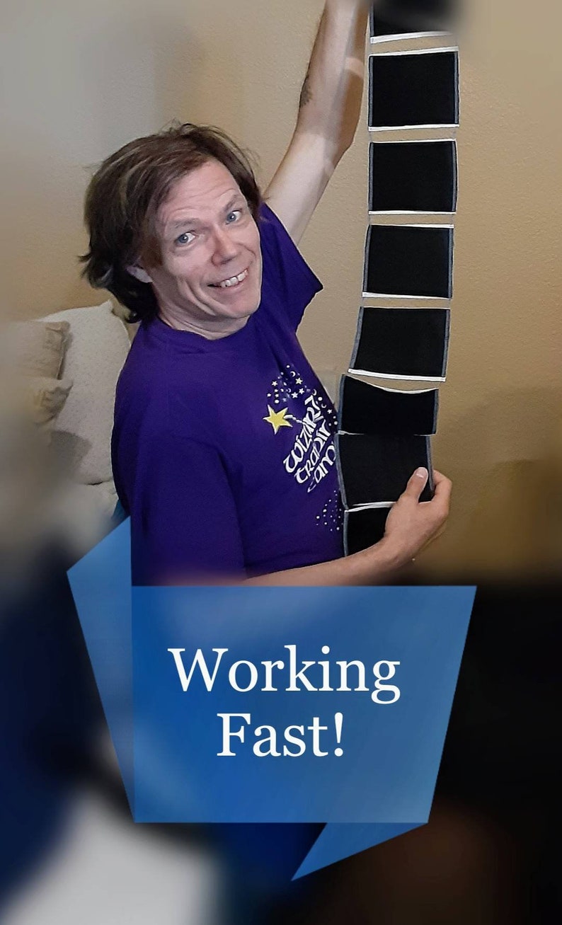 May include: A person in a purple t-shirt holding a strip of black objects. The shirt has a graphic with text and a star. The image has the text "Working Fast!" in a blue banner.