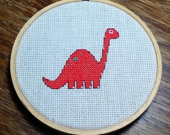 Orange dinosaur cross stitch pattern, counted cross stitch PDF pattern. Instant download.